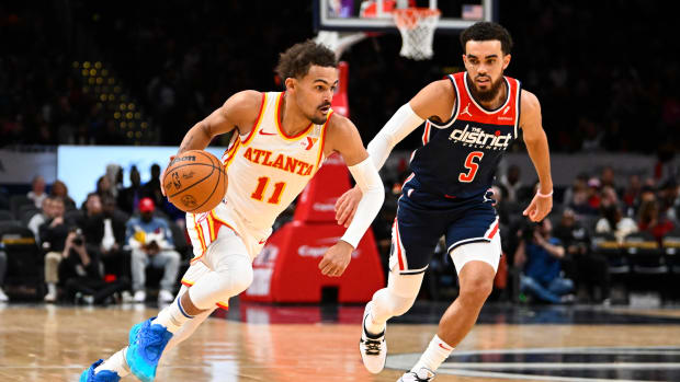 Nov 25, 2023; Washington, District of Columbia, USA; Atlanta Hawks guard Trae Young (11) advances the ball as Washington Wizards guard Tyus Jones (5) looks on during the first half at Capital One Arena. Mandatory Credit: Brad Mills-USA TODAY Sports